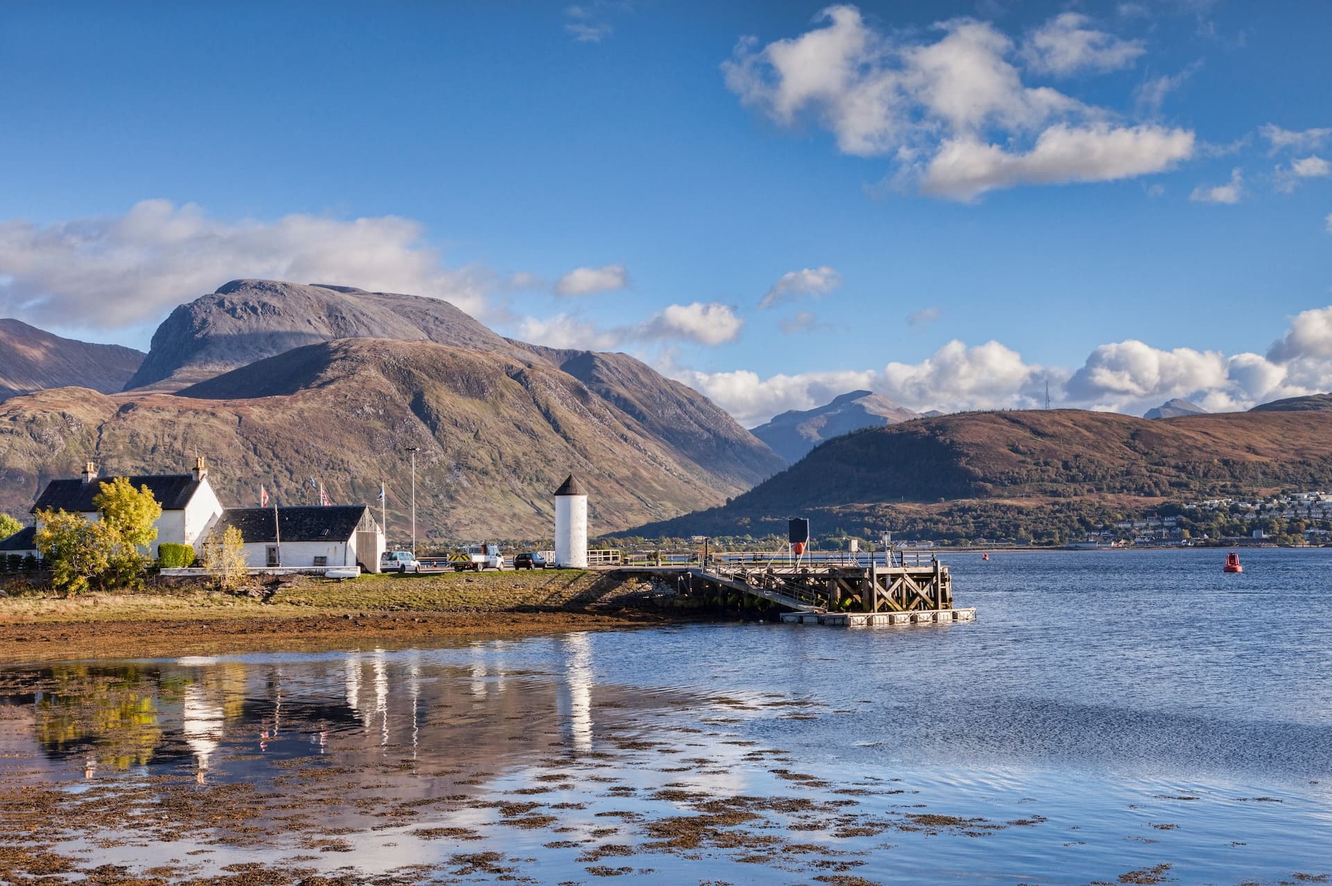 Corpach buildings and pier on Loch Linnhe with Ben Nevis mountains in the background, Fort William.