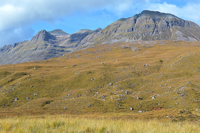 Liathach mountain peaks in Torridon with rocky slopes and grassy foreground